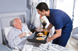 Offering breakfast to old senior man