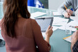 Woman using tablet computer in business meeting