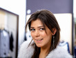 young woman in a shop buying clothes