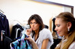 young woman in a shop buying clothes
