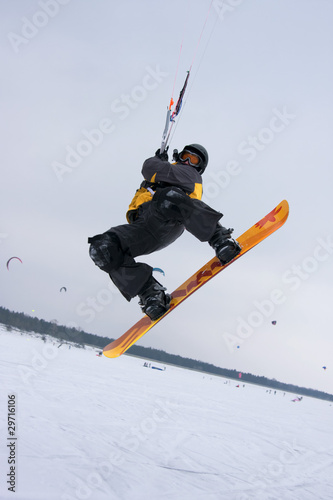 Photo: The snowkiter on the orange snowboard is jumping over the camera The snowkiter on the orange snowboard is jumping over the camera