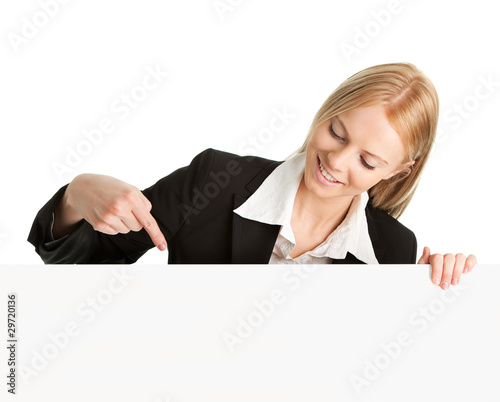 Photo: Cheerful businesswomen presenting empty board Cheerful businesswomen presenting empty board