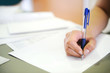 Female hand writing in document