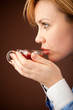 Five-o'clock tea. White collar woman relaxing with hot tea