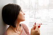 Brunette woman look at window and relaxing with hot tea