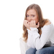 Stressed young woman eating her nails
