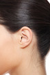 Young caucasian woman ear.