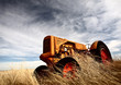 Tumbleweeds piled against abandoned tractor Tumbleweeds piled against abandoned tractor