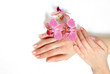 Beautiful hand with perfect nail french manicure and purple orch