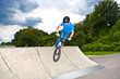 boy has fun with his BMX at the skatepark