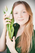 Young blonde girl with tulips, with grey background Young blonde girl with tulips, with grey background