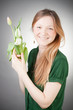Young blonde girl with tulips, with grey background Young blonde girl with tulips, with grey background