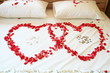 Red rose hearts on white bed. Red rose hearts on white bed.