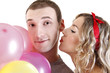 beautiful girl kissing a boy with a baloons