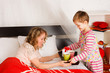 boy brought breakfast to the mother in a bed
