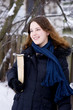 Smiling young girl with book in winter Smiling young girl with book in winter