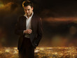 Elegant young handsome man over night city background Elegant young handsome man over night city background