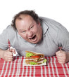 homme obèse dévorant un sandwich