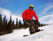 Snowboarder jumping through air with  blue sky in background