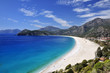 Sweeping white beach with blue sky and sea