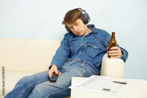 Photo: People relaxing at home after work People relaxing at home after work