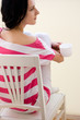 Caucasian young woman sitting on the chair and drinking tea Caucasian young woman sitting on the chair and drinking tea