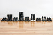 Row of shoes and boots on a wooden floor Row of shoes and boots on a wooden floor