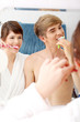 Young couple cleaning teeth