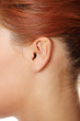 Young caucasian woman ear .