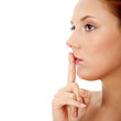 Young woman gesturing for quiet