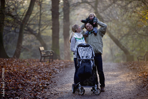 Photo: A family standing in the park A family standing in the park