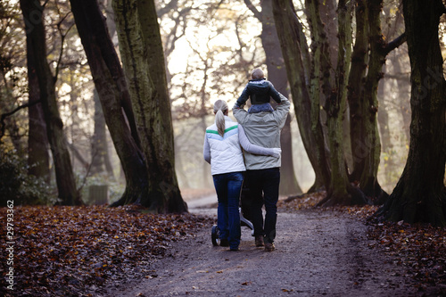 Photo: A family walking in the park A family walking in the park
