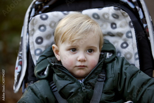 Photo: Portrait of a young boy sitting in a stroller Portrait of a young boy sitting in a stroller
