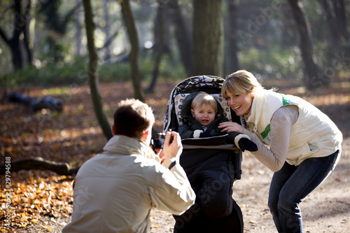 Photo: A father photographing his partner and child, child crying A father photographing his partner and child, child crying