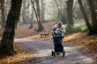 A young mother checking on her son in a stroller