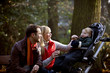 A young couple feeding their son in the park
