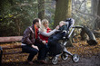 A young couple feeding their son in the park