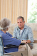 Senior couple talking in the living room at home Senior couple talking in the living room at home