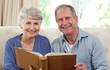 Seniors looking at their photo album Seniors looking at their photo album