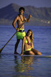 young couple on a paddleboard in a hawaii lagoon
