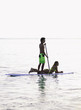 young couple on a paddleboard in a hawaii lagoon young couple on a paddleboard in a hawaii lagoon