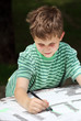 Young child drawing with a pen