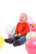 Smiling baby with balloons