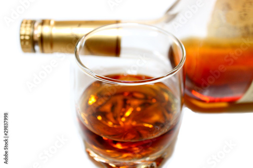Photo: Whiskey in a glass,bottle behind Whiskey in a glass,bottle behind