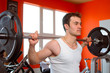Photo: Man lifting weights at the gym Man lifting weights at the gym
