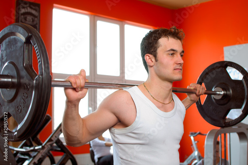 Photo: Man lifting weights at the gym Man lifting weights at the gym