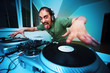 Crazy DJ Scratching on the Turntables at house party Crazy DJ Scratching on the Turntables at house party