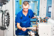 worker operating CNC machine center