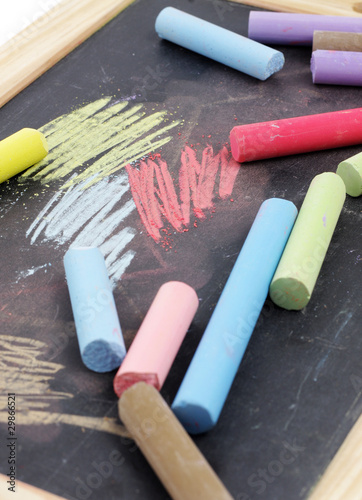 Photo: Chalks and black chalkboard Chalks and black chalkboard