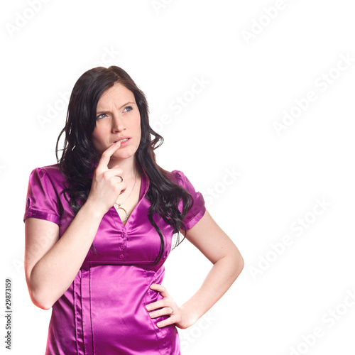 Photo: Portrait of young woman thinking and looking up at white space Portrait of young woman thinking and looking up at white space